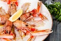 Seafood. Langoustine, scampi or Norway lobster with lemon on white plate