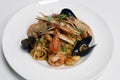 Seafood linguine pasta with langostino, octopus, squid rings, shrimps, mussels, scampi and clams in white wine marinara tomato