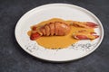 Seafood lobster with soup sauce. Cooked lobster on restaurant table, close-up Royalty Free Stock Photo