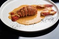 Seafood lobster with soup sauce. Cooked lobster on restaurant table, close-up Royalty Free Stock Photo