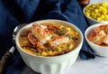 Seafood lunch a la chowder. Hot spicy corn cream soup with bacon and shrimps. Royalty Free Stock Photo