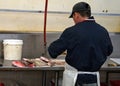 Asian Market Employee Cleaning Fish