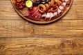 Seafood and meat platter on wooden table background
