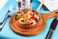 Warm salad of grilled fish pieces, shrimps and mussels in a frying pan Royalty Free Stock Photo