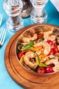 Warm salad of grilled fish pieces, shrimps and mussels in a frying pan Royalty Free Stock Photo