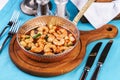 Warm salad of grilled fish pieces, shrimps and mussels in a frying pan, with grilled vegetables Royalty Free Stock Photo