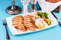 Grilled seafood. Salmon fish steak with greens, broccoli, cauliflower, carrots, cucumber, lemon and chili. Royalty Free Stock Photo