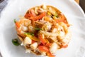 Seafood Mexican tostada with onion and peppers