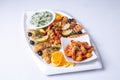 seafood mixture on a white grill. Delicious grilled fish, shrimp in sauce and salmon on the table Royalty Free Stock Photo