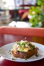 Seafood morning breakfast sandwich with shrimps, egg omlette, and loots of fresh greenery on top.