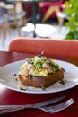 Seafood morning breakfast sandwich with shrimps, egg omlette, and loots of fresh greenery on top.