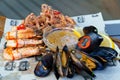 seafood. mussel, squid and shrimp cooked on the grill with sauce and vegetables.