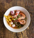 Seafood noodle in a white bowl