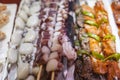 Seafood octopus tentacles on sticks, fresh octopus on a stick Royalty Free Stock Photo
