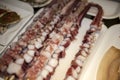 Seafood octopus tentacles on sticks, fresh octopus on a stick Royalty Free Stock Photo