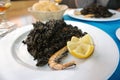 Seafood paella with black squid ink