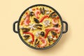 Seafood paella dish on yellow background Royalty Free Stock Photo