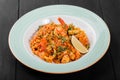 Seafood paella with rice, tomato sauce, langoustine, mussels, squid, shrimp and greens Royalty Free Stock Photo