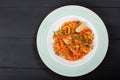 Seafood paella with rice, tomato sauce, langoustine, mussels, squid, shrimp and greens Royalty Free Stock Photo