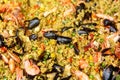 Seafood paella with rice, tomato sauce, langoustine, mussels, squid, shrimp. Royalty Free Stock Photo