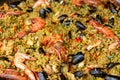Seafood paella with rice, tomato sauce, langoustine, mussels, squid, shrimp. Royalty Free Stock Photo