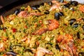 Seafood paella with rice, tomato sauce, langoustine, mussels, squid, shrimp. Royalty Free Stock Photo