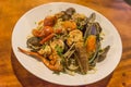 Seafood pasta Spaghetti with Clams, Prawns, Seafood Cocktail in set have salad on wood table