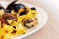 Seafood pasta spaghetti linguine wish mussels, clams, tomato sauce, fresh parmesan on the white plate in restaurant in Catania, Si