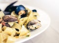 Seafood pasta spaghetti linguine wish mussels, clams, tomato sauce, fresh parmesan on the white plate in restaurant in Catania, Royalty Free Stock Photo