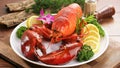 Seafood plate with red lobster shrimp shellfish and fresh vegetables lemon herb, Seafood fresh cooked seafood on white plate on Royalty Free Stock Photo