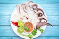 Seafood plate squid food on white plate, Fresh squid cooked boiled steam with vegetable salad lemon lime and seafood sauce chili Royalty Free Stock Photo