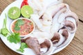 Seafood plate squid food on white plate, Fresh squid cooked boiled steam with vegetable salad lemon lime and seafood sauce chili Royalty Free Stock Photo