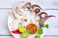 Seafood plate squid food on white plate, Fresh squid cooked boiled steam with vegetable salad lemon lime and seafood sauce chili Royalty Free Stock Photo