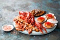 Seafood platter. Assorted seafood - smoked prawns and mussels on skewers, crayfish, fried scallops with red caviar, shell Royalty Free Stock Photo