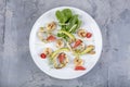 Seafood platter with deep fried squid rings, shrimp decorated with lemon on fresh arugula. Mediterranean appetizers. Top view Royalty Free Stock Photo
