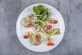 Seafood platter with deep fried squid rings, shrimp decorated with lemon on fresh arugula. Mediterranean appetizers. Top view Royalty Free Stock Photo