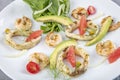 Seafood platter with deep fried squid rings, shrimp decorated with lemon on fresh arugula. Mediterranean appetizers. Top view Royalty Free Stock Photo