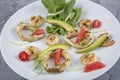 Seafood platter with deep fried squid rings, shrimp decorated with lemon on fresh arugula. Mediterranean appetizers. Top view Royalty Free Stock Photo