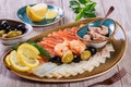 Seafood platter. Fresh cod liver, salmon, shrimp, slices fish fillet, decorated with herb, lemon