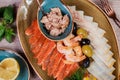 Seafood platter. Fresh cod liver, salmon, shrimp, slices fish fillet, decorated with herb, lemon and olives