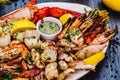 Seafood platter. Grilled lobster, shrimps, scallops, langoustines, octopus, squid on white plate Royalty Free Stock Photo