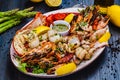 Seafood platter. Grilled lobster, shrimps, scallops, langoustines, octopus, squid on white plate Royalty Free Stock Photo