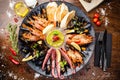 Seafood platter for 2-4 persons. Lobster, octopus, blue mussels, Argentina king prawns, tuna tartare. Delicious healthy Royalty Free Stock Photo