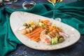 Seafood platter Prawns, Scallops, Salmon, crab claw and white fish woth glass of white wine on turquoise background Royalty Free Stock Photo
