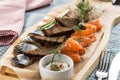 Seafood platter with salmon slice, pangasius fish, salted herring rey bread toast on wooden background vodka appetizer Royalty Free Stock Photo