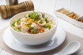 Seafood Porridge,Boiled rice soup with Sliced fish squid and shrimp in white bowl.