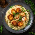 Seafood Risotto with Scallops in a plate. Dark wooden background. Top view