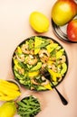 Seafood Salad with Mango, Shrimps and Avocado, Walnut, Spinach and Arugula. Top view, pink background Royalty Free Stock Photo