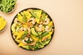 Seafood Salad with Mango, Shrimps and Avocado, Walnut, Spinach and Arugula. Top view, pink background Royalty Free Stock Photo