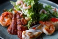 Seafood salad. Shrimps, eel, squids, lettuce. Against a dark background Royalty Free Stock Photo